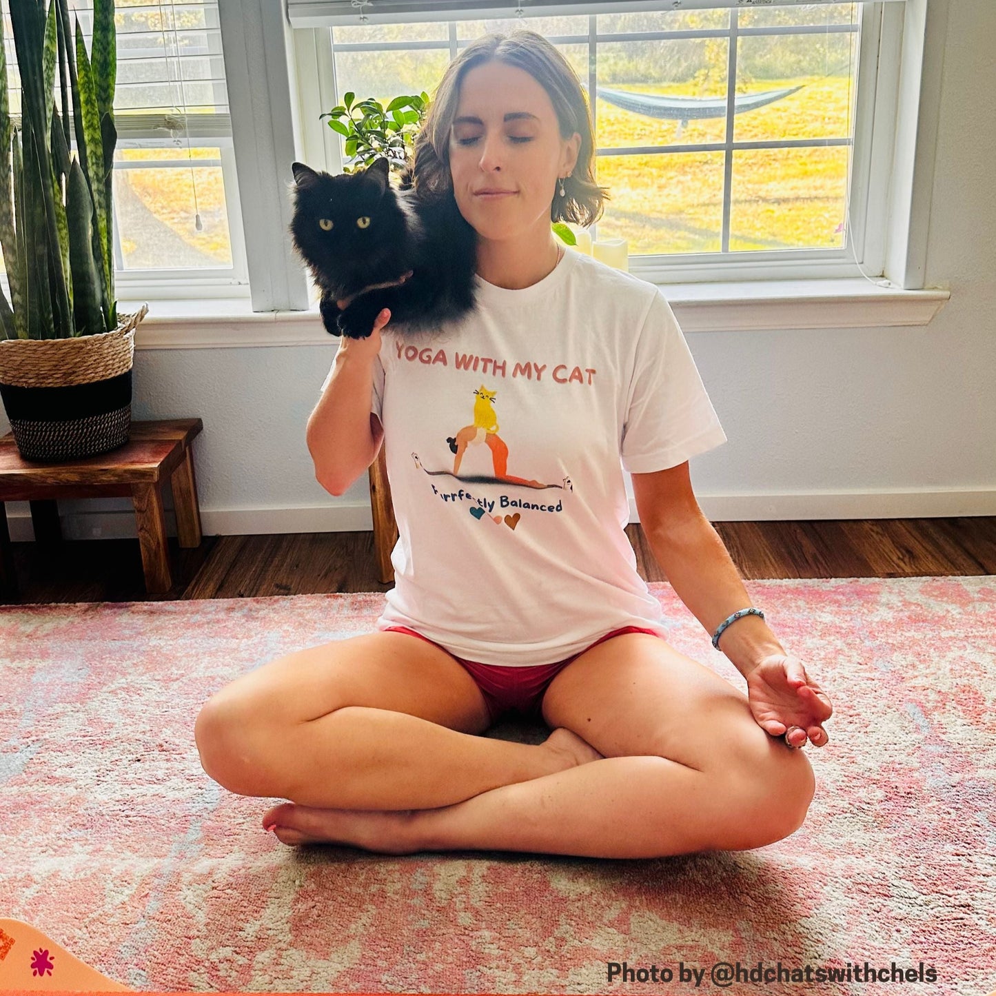 Chelsea Roberts wearing Yoga with My cat tee doing yoga with her cat