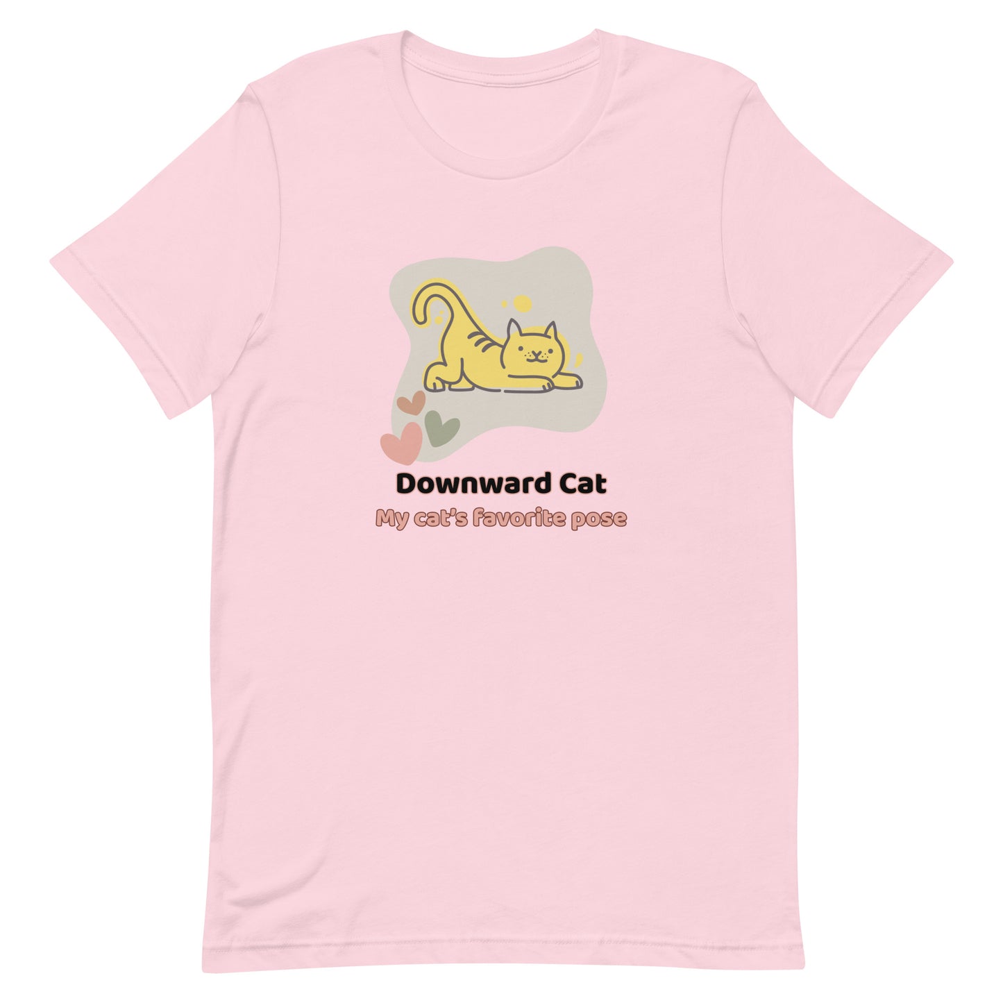 Soft pink unisex yoga t-shirt featuring a playful cartoon illustration of a cat doing a yoga stretch, paired with the text “Downward Cat: My Cat’s Favorite Pose.”