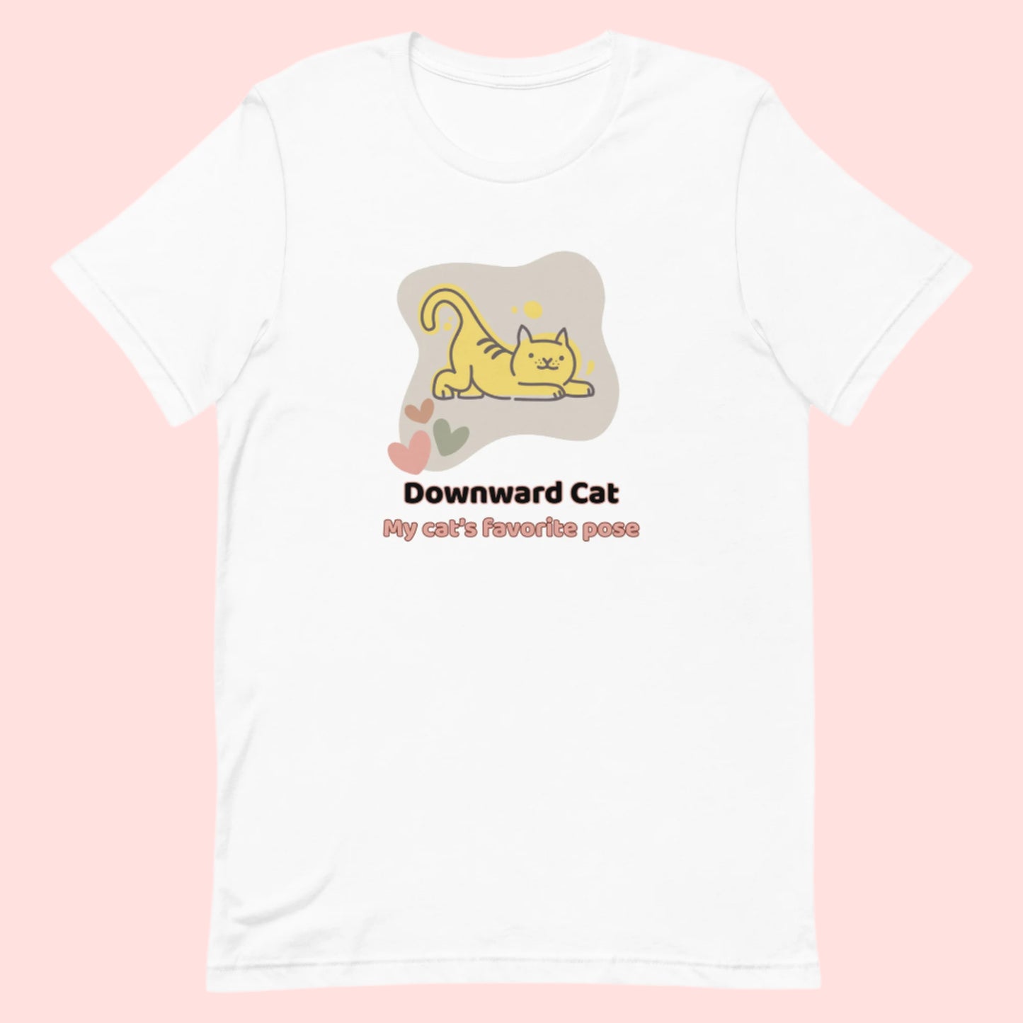 White unisex yoga t-shirt featuring a playful cartoon illustration of a cat doing a yoga stretch, paired with the text “Downward Cat: My Cat’s Favorite Pose.”