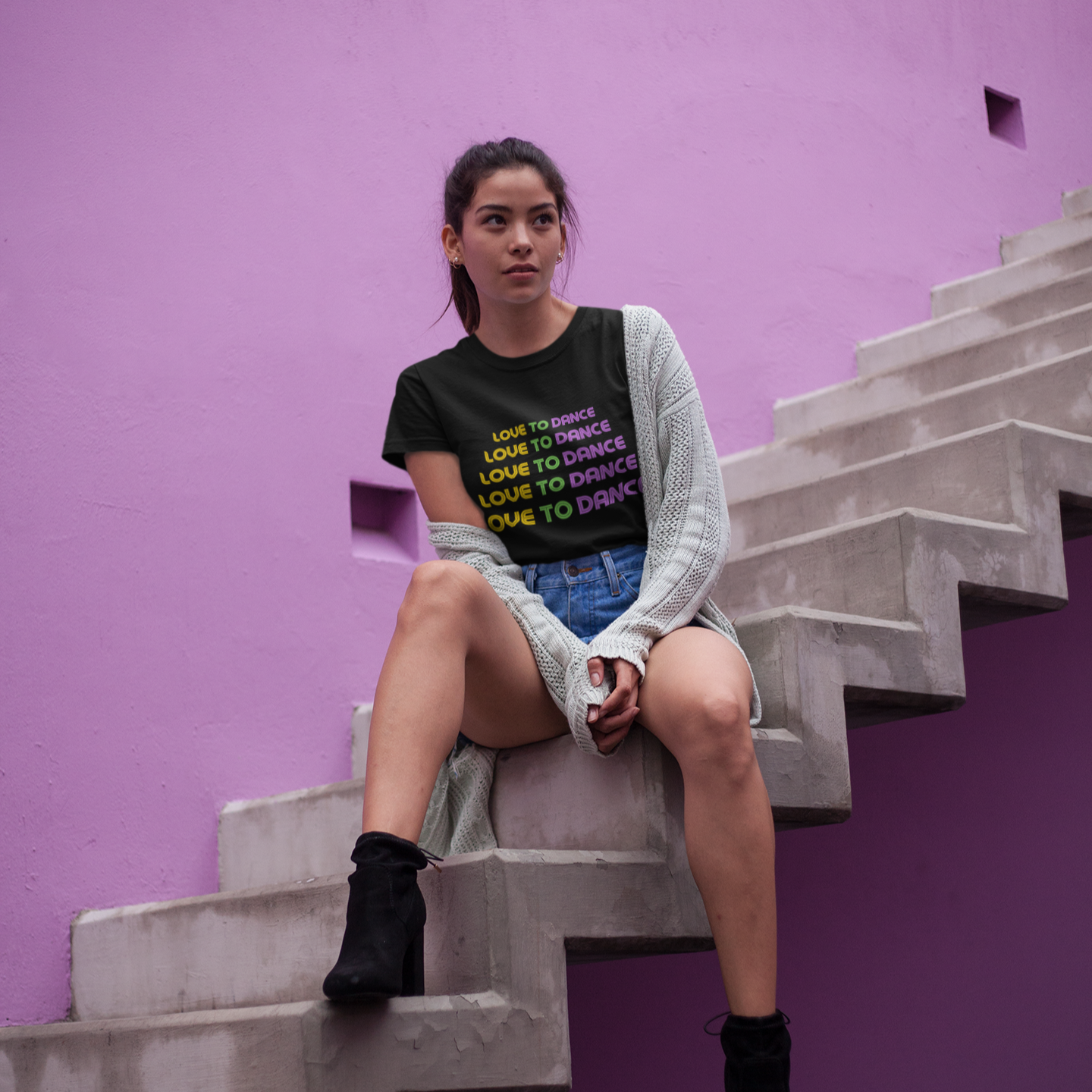 Woman wearing a black unisex dance t-shirt with the phrase “Love to Dance” in bold, minimalist font. A clean and uplifting design that celebrates pure joy through movement—ideal for dance lovers of all styles.