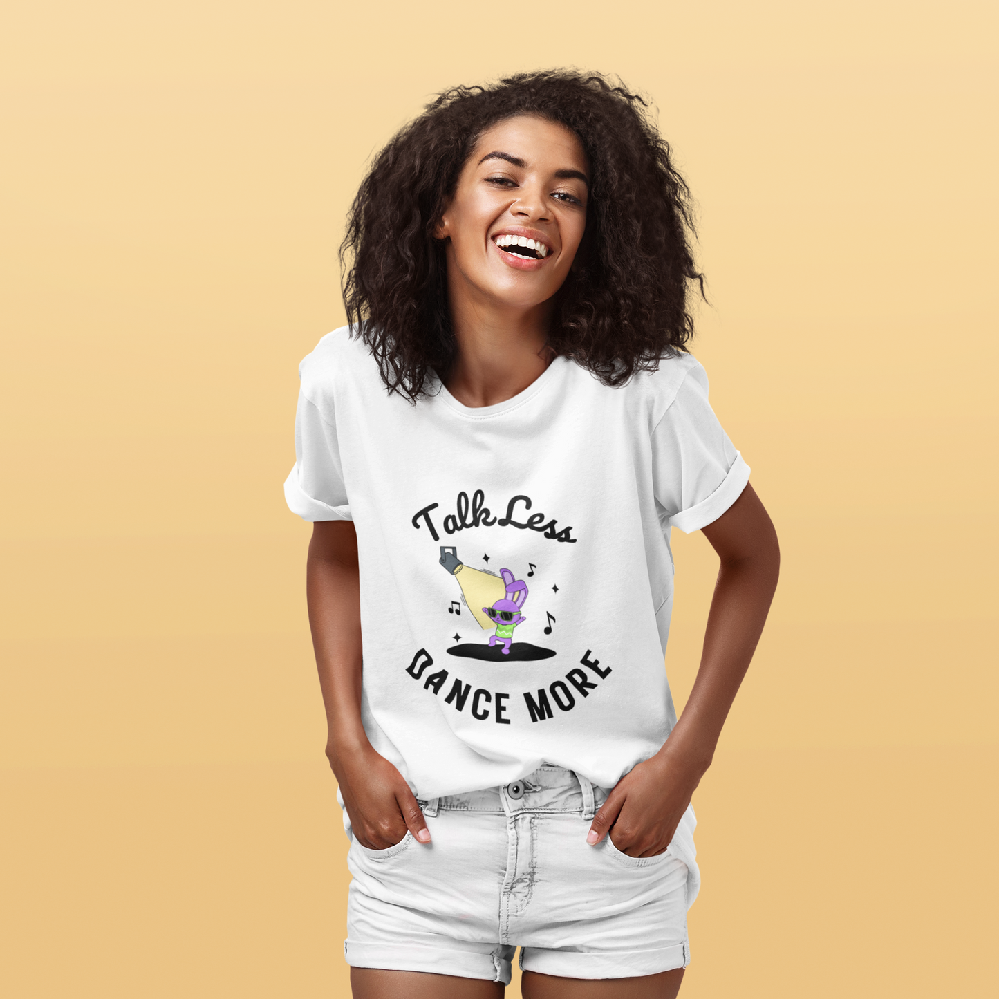 Woman wearing white unisex dance t-shirt with the phrase “Talk Less Dance More” in bold, confident typography. A direct, high-energy design for people who let their moves speak louder than words.