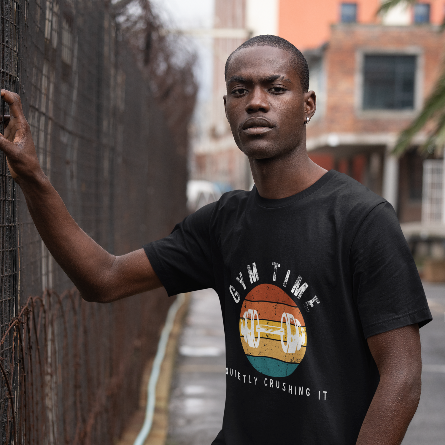 Man wearing black unisex gym t-shirt with the phrase “Gym Time Quietly Crushing It” in clean, confident font.