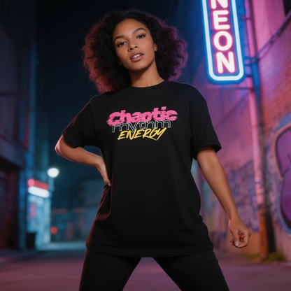 Person wearing a black t-shirt with text  saying "Chaotic Rhythm Energy" in an urban setting with neon lights and graffiti.