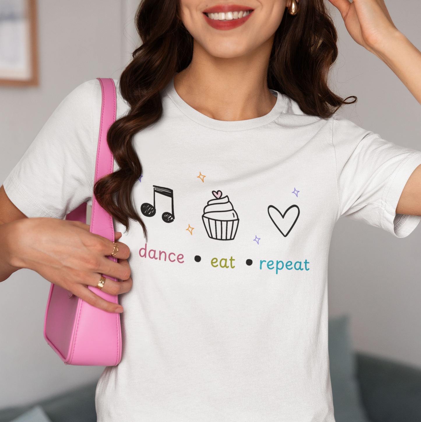Woman wearing a white tee with text "Dance Eat Repeat"