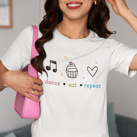 Woman wearing a white tee with text "Dance Eat Repeat"