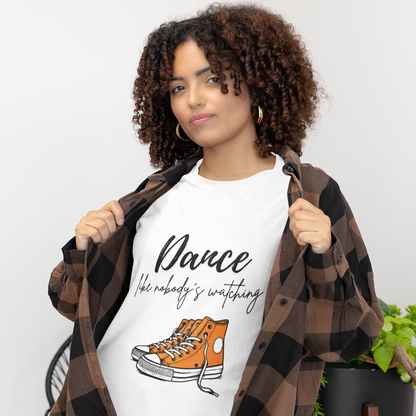 Woman wearing white unisex dance t-shirt with the phrase “Dance Like Nobody’s Watching”. A carefree and uplifting design for those who dance freely and unapologetically.
