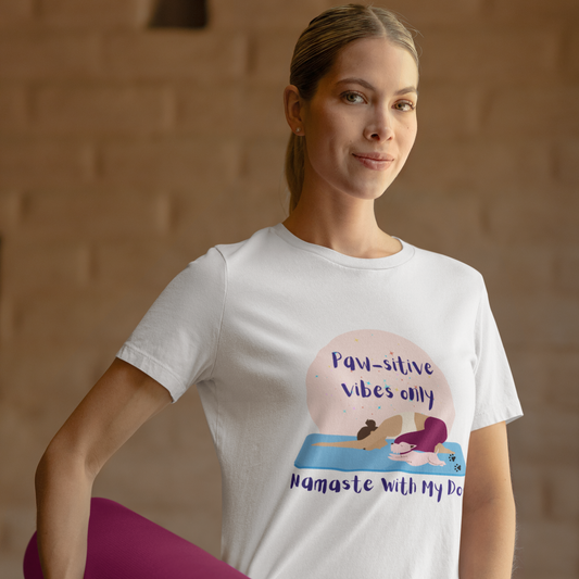 Woman wearing a white unisex yoga t-shirt with the phrase “Paw-sitive Vibes Only Namaste with My Dog”