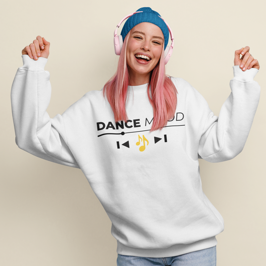 White unisex Dance Mood On sweatshirt featuring black text and yellow music note print, modeled by a woman with pink hair, blue beanie, and pink headphones.