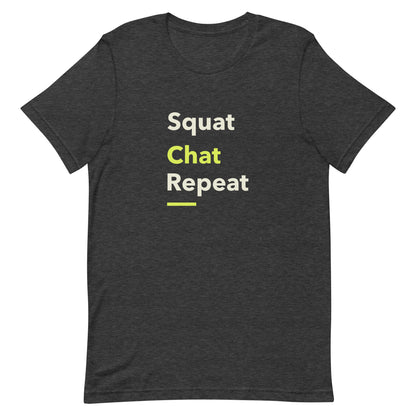 Dark grey unisex gym t-shirt with the phrase “Squat Chat Repeat.” A cheeky and relatable gym-themed design for fitness lovers who mix reps with conversation.