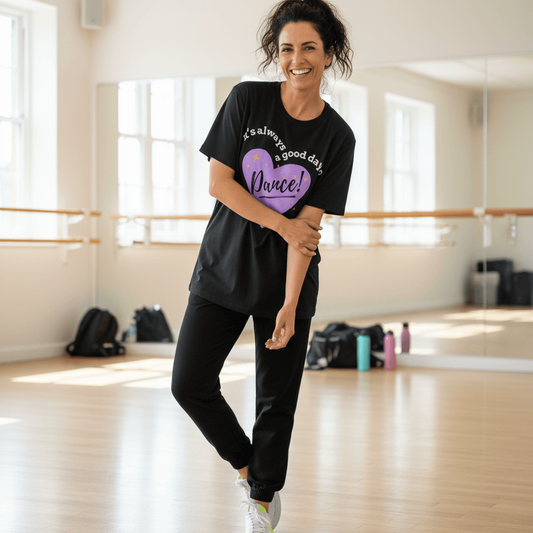Woman smiling in a dance studio wearing a black “It’s Always a Good Day to Dance” t-shirt from MM Tee Lab
