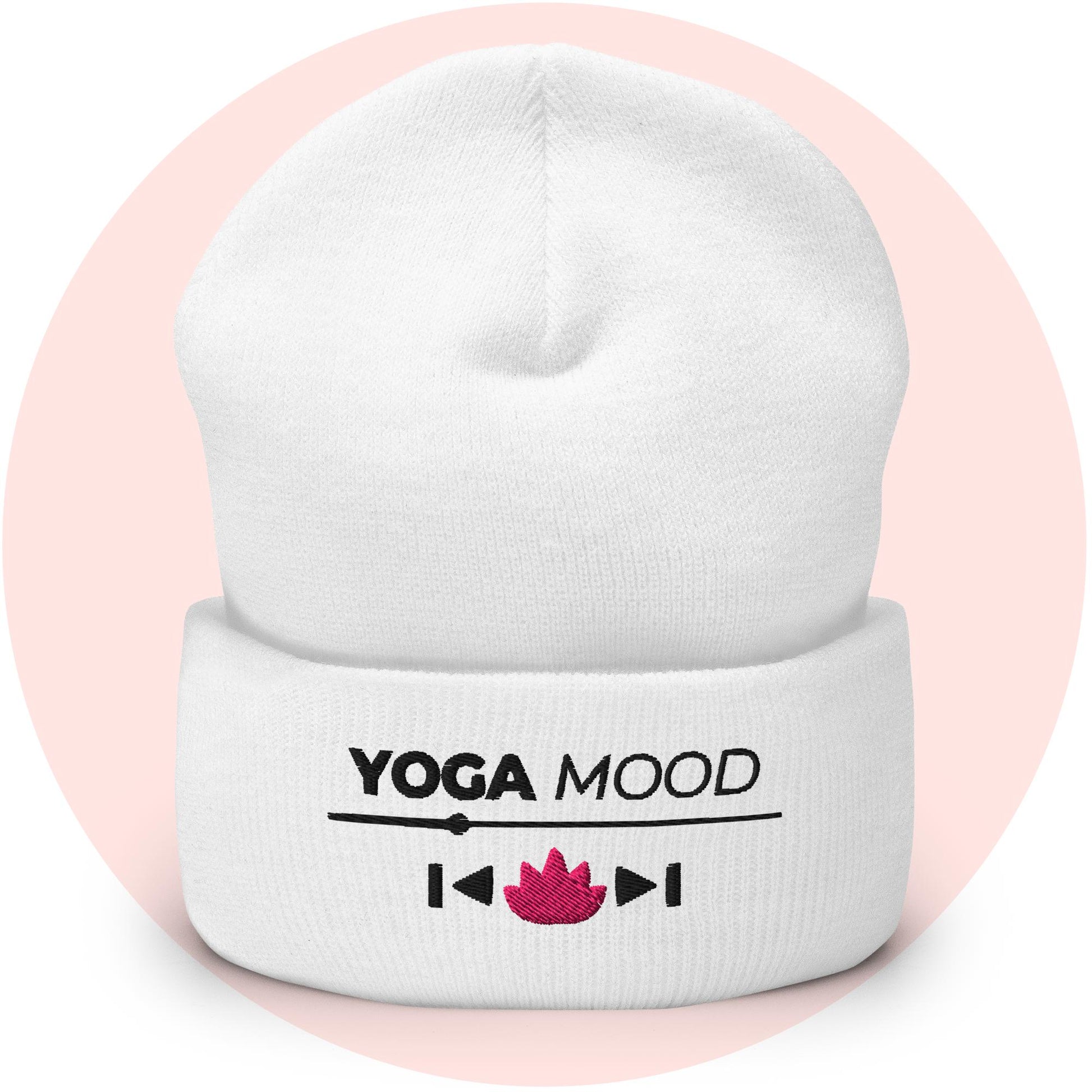 White cuffed beanie from the Yoga Mood On collection with embroidered text and pink lotus icon, displayed on a soft pink background.