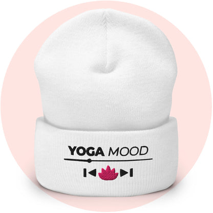 White cuffed beanie from the Yoga Mood On collection with embroidered text and pink lotus icon, displayed on a soft pink background.